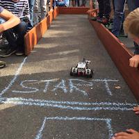 Children playing with a racing car.